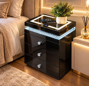 A MODREN BEDSIDE SIDETABLE IN BLACK FINISH WITH LIGHT AND PHONE CHARGING OPTION AND 3 DRAWERS. MEASUREMENTS 45X40X60CM