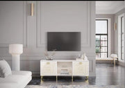 GUCCI SOFT GOLD TV UNIT  WITH ELEGANT DESIGN BEIGE SOFT GOLD FINISH FEATURING 2 DOORS AND A CENTRAL OPEN SHELF. WITH MDF STRUCTURE AND TEMPERED GLASS TOP AND GOLD STAINLESS STEEL LEGS 160X65X45CM