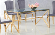MAJESTIQUE DINING TABLE FEATURES A GOLD BASE WITH A TRANSPARENT GLASS TOP COMBINING LUXURY AND MODREN ELEGANCE 150X90X75CM