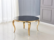 BAROQUE ROUND DINING TABLE FEATURES A GOLD BASE WITH A BLACK MARBLE EFFECT TOP COMBINING CLASSIC LUXURY WITH BOLD ELEGNACE MEASURING 130X75CM .