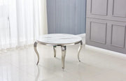 BAROQUE ROUND DINING TABLE FEATURES A SILVER BASE WITH A WHITE MARBLE EFFECT TOP COMBINING CLASSIC ELEGANCE WITH A MODREN TOUCH 130X75CM