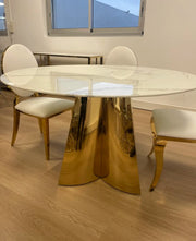 CAPUCINE 130X75CM DINING TABLE FEATURES A WHITE MARBLE TOP WITH GOLD LEGS .