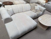 A MODREN BEIGE L-SHAPED SECTIONAL SOFA IN BEIGE  WITH SOFT TEXTURED FABRIC AND ROUNDED ARMRESTS.MEASURING 270X160CM