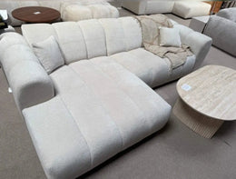 A MODREN BEIGE L-SHAPED SECTIONAL SOFA IN BEIGE  WITH SOFT TEXTURED FABRIC AND ROUNDED ARMRESTS.MEASURING 270X160CM