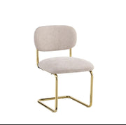 ARC CHAIR WITH GOLD LEGS AND ICED BROWN FABRIC UPHOLSTERY.