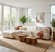 A LARGE BEIGE SECTIONAL SOFA WITH ROUNDED ARMS. MEASUREMENT 280X186CM