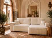 A MODREN CREAM RIBBED SECTIONAL SOFA WITH A ROUNDED CHAISE WITH PLUSH CUSHIONS AND VERTICAL DETAILING , WITH BEIGE FINISH. MEASUREMENT 262X105X85CM
