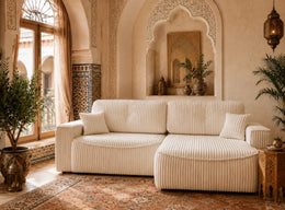 A MODREN CREAM RIBBED SECTIONAL SOFA WITH A ROUNDED CHAISE WITH PLUSH CUSHIONS AND VERTICAL DETAILING , WITH BEIGE FINISH. MEASUREMENT 262X105X85CM