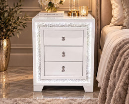 A MODREN BEDSIDE TABLE IN WHITE WITH DIAMOND DESIGN WITH LIGHTS AND 3 DRAWERS. MEASUREMENT 45X40X60CM