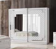 CRISTAL BEDROOM SET WITH WHITE/SILVER FEATURES A MODREN AND ELEGANT DESIGN . THE SET INCLUDES A 160X200CM BED WITHOUT MATRESS WITH 2 SLIDING DOOR WARDROBE 200X62X210CM AND COMMODE WITH LIGHT 125X47X161CM AND MIRROR  AND 2 BEDSIDE TABLE 60X47X51CM