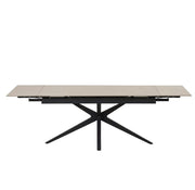 TONIA EXTENDABLE DINING TABLE FEATURES A BLACK METAL BASE WITH A BEIGE TRAVERTINE CERAMIC TOP COMBINING MODREN ELEGANCE AND DURABILITY.160/240X90X76CM