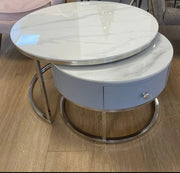 NESTING COFFE TABLE SET 80+60 CM FEATURES A WHITE MARBLE EFFECT TOP WITH GREY DRAWERS AND SILVER LEGS.