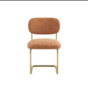 ARC CHAIR WITH GOLD LEGS AND TERRACOTTA MARBELLA FABRIC UPHOLSTERY.