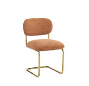ARC CHAIR WITH GOLD LEGS AND TERRACOTTA MARBELLA FABRIC UPHOLSTERY.