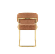 ARC CHAIR WITH GOLD LEGS AND TERRACOTTA MARBELLA FABRIC UPHOLSTERY.