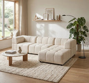 A LARGE BEIGE SECTIONAL SOFA WITH ROUNDED ARMS. MEASUREMENT 280X186CM