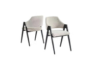 A modern armchair with a cream upholstered seat and back, BLACK wooden frame, tapered legs, and sculptural open arms.